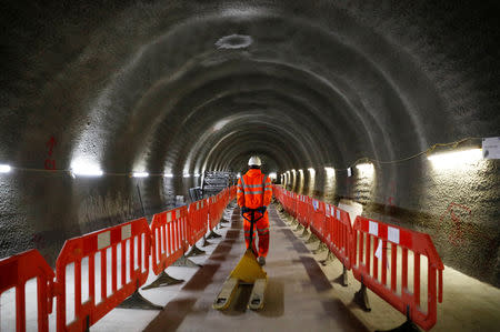 FILE PHOTO: A construction worker drags a trolley down a tunnel at the site for the new Crossrail station in Tottenham Court Road, in London, Britain, November 16, 2016. REUTERS/Stefan Wermuth/File Photo
