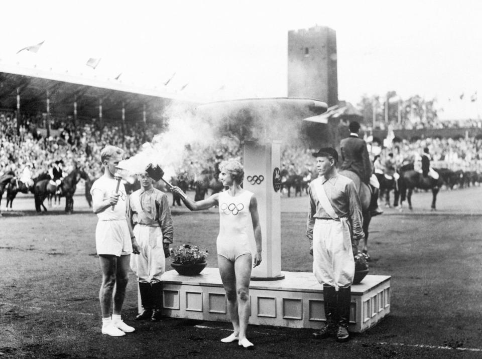 <p>The Olympic torch is lit during the opening ceremony for the 1956 Summer Olympics. Meanwhile, a separate ceremony took place in Stockholm, Sweden. Australia's strict animal quarantine rules made the second location necessary so that equestrian events could be held. </p>