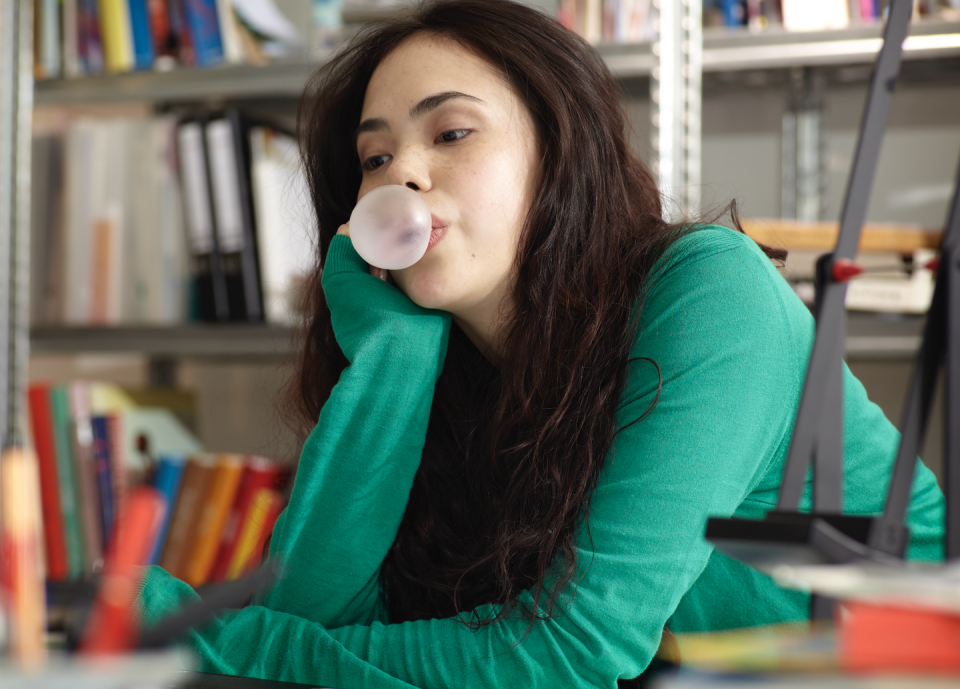 woman blowing bubblegum