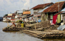 Same color: Houses, mosques, madrassas, grocery shops, furniture stalls, all built with patches of wood, the same color as the canals, nailed to each other. (