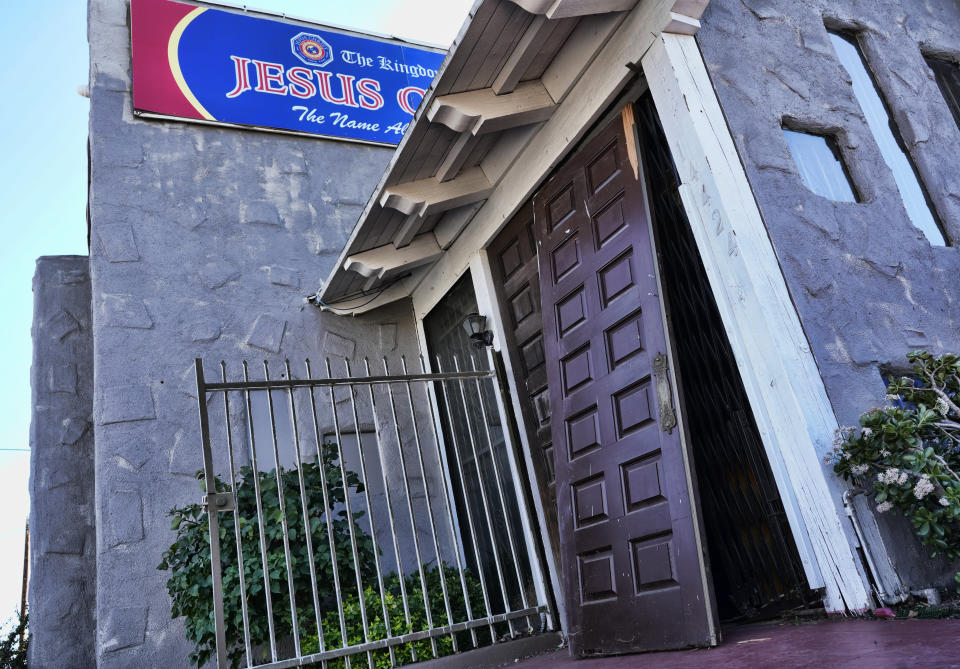 A smashed in door is seen at the entrance of the Kingdom of Jesus Christ Church in the Van Nuys section of Los Angeles on Wednesday, Jan. 29, 2020. The FBI raided a Philippines-based church in Los Angeles to arrest leaders of an alleged immigration fraud scheme that resulted in sham marriages. Federal prosecutors said Wednesday that three leaders of the local branch of the Kingdom of Jesus Christ were arrested in morning raids. (AP Photo/Richard Vogel)