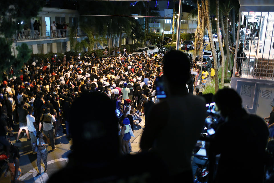 MIAMI BEACH, FLORIDA - MARCH 21: People gather while exiting the area as an 8pm curfew goes into effect on March 21, 2021 in Miami Beach, Florida. College students have arrived in the South Florida area for the annual spring break ritual, prompting city officials to impose an 8pm to 6am curfew as the coronavirus pandemic continues. Miami Beach police have reported hundreds of arrests and stepped up deployment to control the growing spring break crowds. (Photo by Joe Raedle/Getty Images)