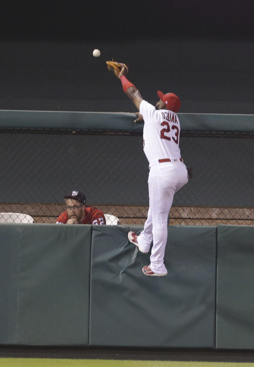 St. Louis Cardinals left fielder Marcell Ozuna (23) can't quite make the catch on a two-run home run ball hit by Washington Nationals' Juan Soto in the seventh inning of a baseball game, Monday, Aug. 13, 2018, in St. Louis. (AP Photo/Tom Gannam)