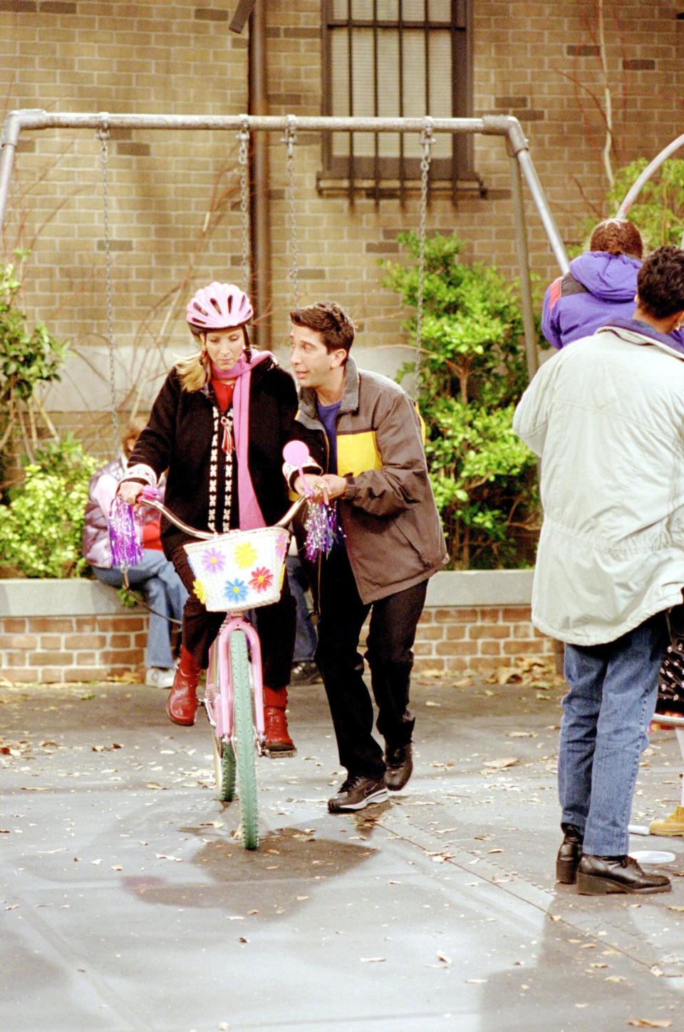 Ross helping Phoebe learn to ride a bike