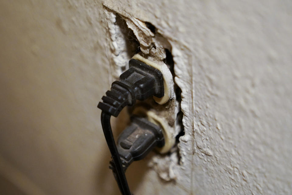 An uncovered electrical outlet can be seen inside Kim Carlson's apartment at the Delta Pines apartment complex, Friday, Nov. 4, 2022, in Antioch, Calif. Despite a landmark renter protection law approved by California legislators in 2019, tenants across the country’s most populous state are taking to ballot boxes and city councils to demand even more safeguards. They want to crack down on tenant harassment, shoddy living conditions and unresponsive landlords that are usually faceless corporations. (AP Photo/Godofredo A. Vásquez)