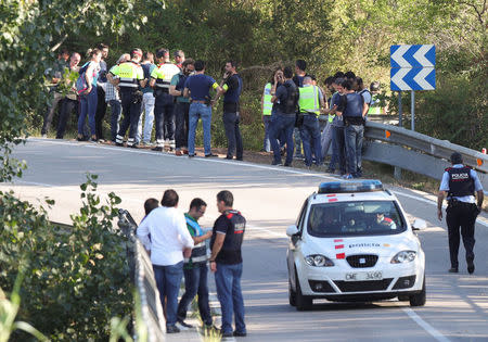 Police officers stand at the place where Younes Abouyaaqoub, the man suspected of driving the van that killed 13 people in Barcelona last week, was killed by police in Subirats, Spain, August 21, 2017. REUTERS/Albert Gea