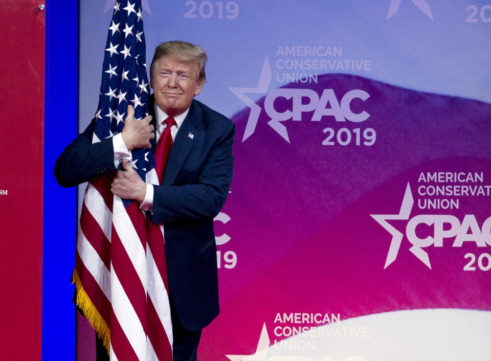 President Donald Trump hugs the American flag as he arrives to speak at Conservative Political Action Conference, CPAC 2019, in Oxon Hill, Md., March 2, 2019. (Photo: Jose Luis Magana/AP)