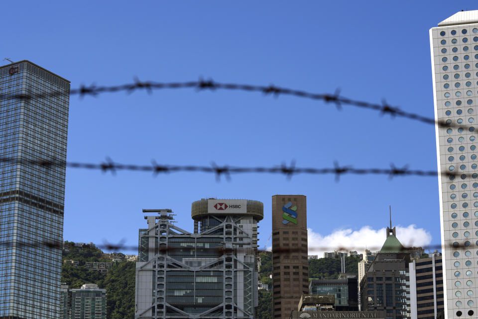 In this Wednesday, Sept. 8, 2021, photo, Commercial buildings are seen in Hong Kong. Banks in Hong Kong, Macao and China's Guangdong province can expect to launch investment products that are open to residents in these areas as soon as October, according to Hong Kong's monetary authority. (AP Photo/Kin Cheung)