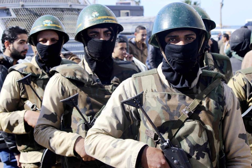 Army soldiers take position to stop clashes between supporters and opponents of ousted Egyptian President Mohamed Mursi around the main university in Alexandria, January 23, 2014. Egypt has seen state violence on an "unprecedented scale" since the army deposed Islamist President Mohamed Mursi last July following mass protests against his rule, Amnesty International said in a report on Thursday. (REUTERS/Al Youm Al Saabi Newspaper)