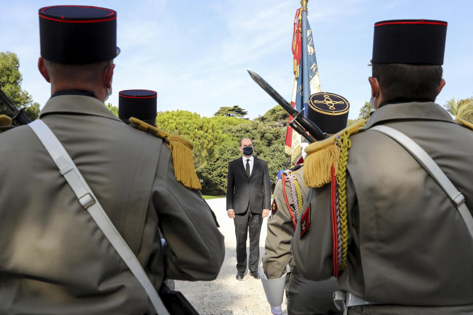 French Prime Minister Jean Castex pays tribune to victims Nadine Devillers, Vincent Loques and Brazil's Simone Barreto Silva. in Nice, southern France, Saturday Nov. 7, 2020, during a ceremony in homage to the three victims of an attack at Notre-Dame de Nice Basilica on October 29, 2020. Three people were killed in an Islamic extremist attack at Notre Dame Basilica in the city of Nice that pushed the country into high security alert. (Valery Hache; Pool via AP)