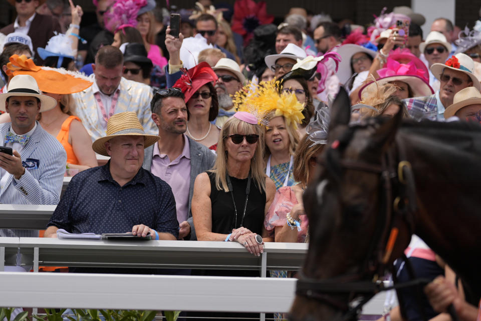 Race fans watch from the stands at Churchill Downs before the 150th running of the Kentucky Derby horse race Saturday, May 4, 2024, in Louisville, Ky. (AP Photo/Brynn Anderson)