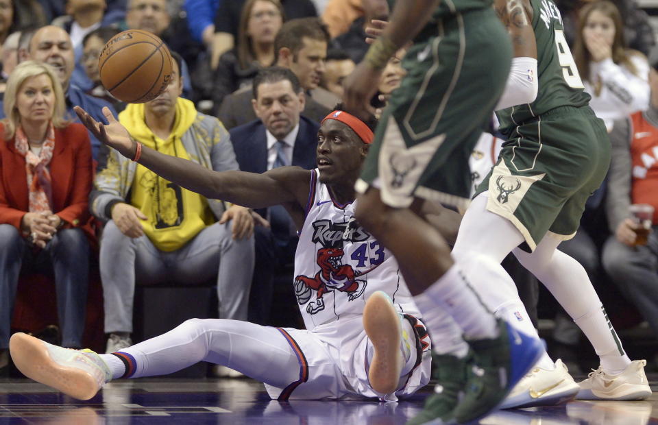 Toronto Raptors forward Pascal Siakam (43) falls as he tries to grab the ball during the first half of the team's NBA basketball game against the Milwaukee Bucks Tuesday, Feb. 25, 2020, in Toronto. (Nathan Denette/The Canadian Press via AP)