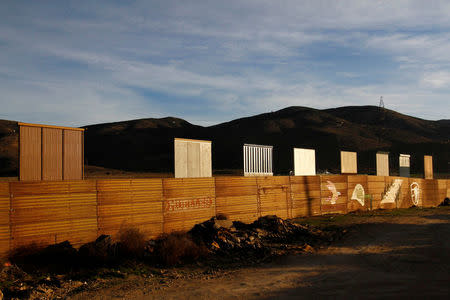 Prototypes for U.S. President Donald Trump's border wall with Mexico are seen behind the current border fence in this picture taken from the Mexican side of the border in Tijuana, Mexico, January 27, 2018. REUTERS/Jorge Duenes