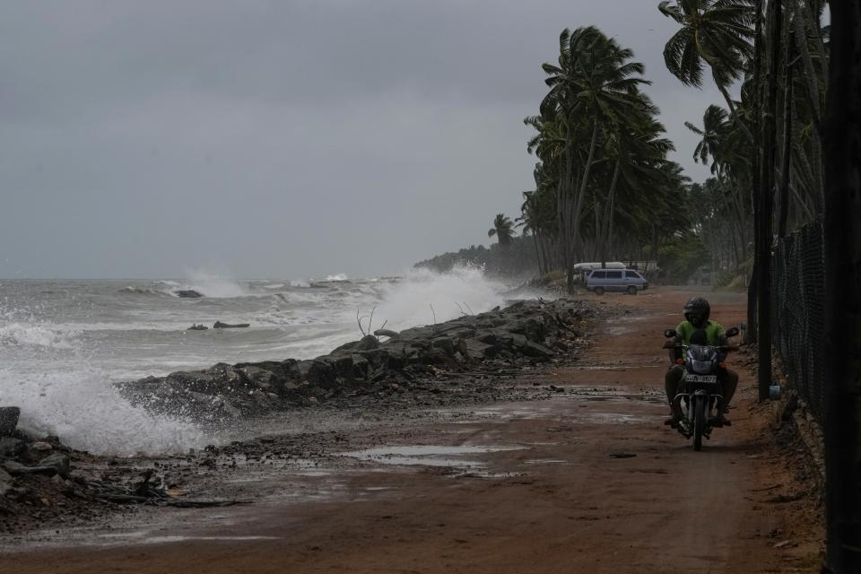 Tidal waves lap a a barrier to slow erosion in Iranawila, Sri Lanka, Friday, June 16, 2023. Much like the hundreds of other fishing hamlets that dot the coastline, the village of Iranawila suffers from coastal erosion. (AP Photo/Eranga Jayawardena)