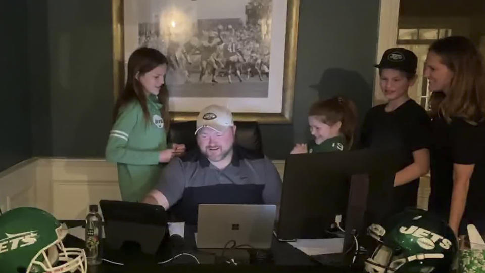In this still image from video provided by the NFL, New York Jets general manager Joe Douglas, seated, works during the second round of the NFL football draft, Friday, April 24, 2020. (NFL via AP)