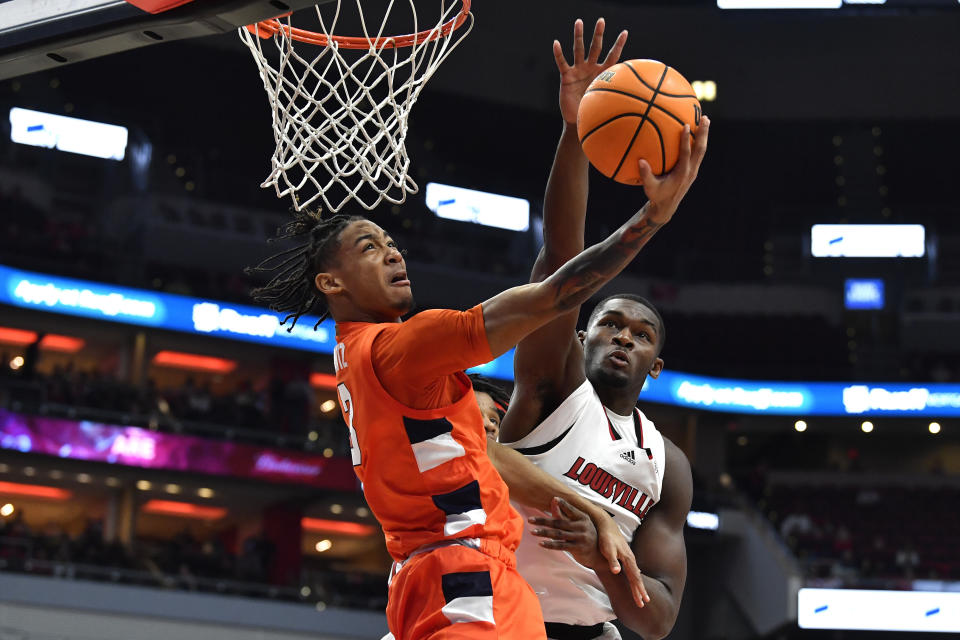 Syracuse guard Judah Mintz (3) attempts a layup past Louisville forward Brandon Huntley-Hatfield (5) during the first half of an NCAA college basketball game in Louisville, Ky., Tuesday, Jan. 3, 2023. (AP Photo/Timothy D. Easley)