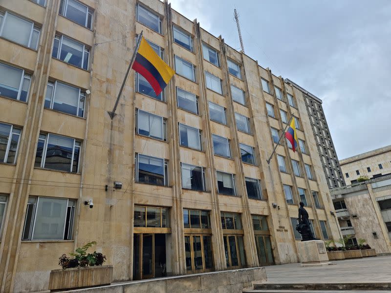 Flags flutter on the facade of the Colombian Ministry of Information and Communications Technologies building in Bogota