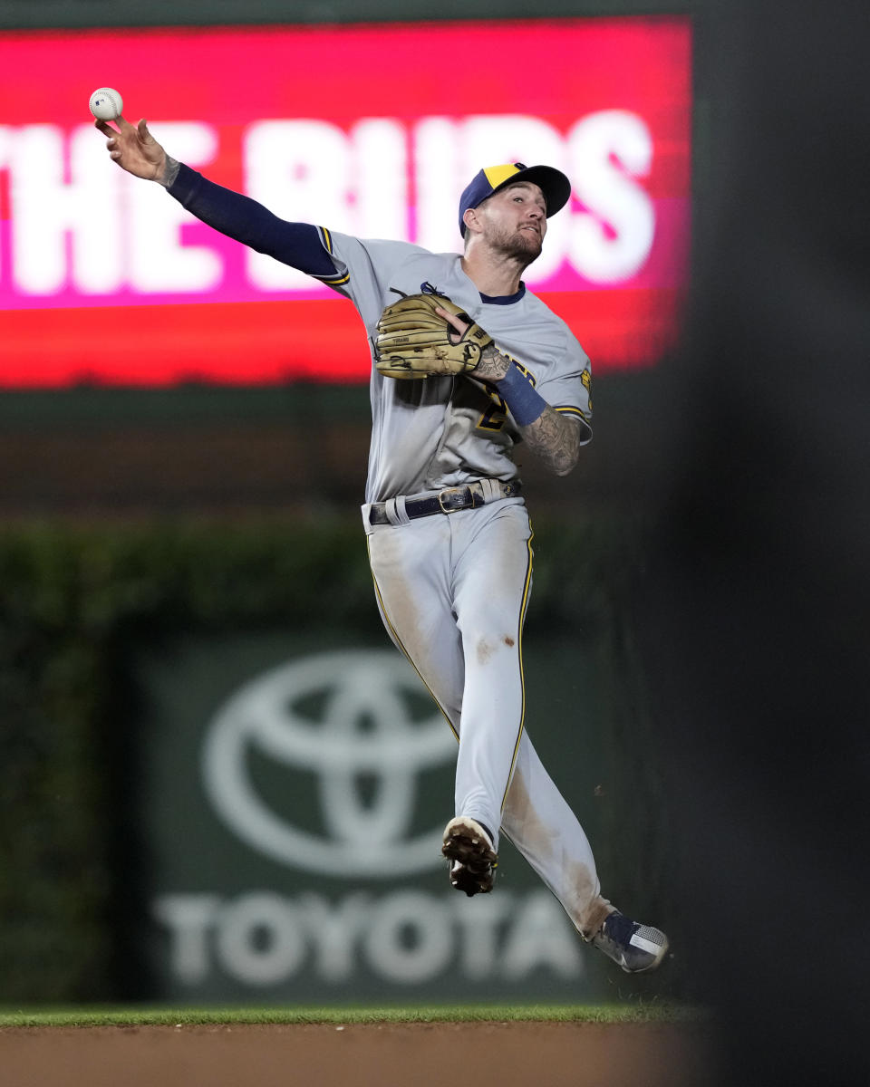 Milwaukee Brewers second baseman Brice Turang throws to first after fielding a ground ball by Chicago Cubs' Yan Gomes, who was safe at first during the seventh inning of a baseball game Tuesday, Aug. 29, 2023, in Chicago. (AP Photo/Charles Rex Arbogast)