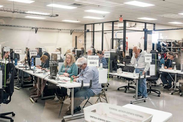 PHOTO: Election workers handle ballots for the US midterm election, in the presence of observers from both Democrat and Republican parties, at the Maricopa County Tabulation and Elections Center (MCTEC) in Phoenix, Ariz., on Nov. 9, 2022. (Olivier Touron/AFP via Getty Images)