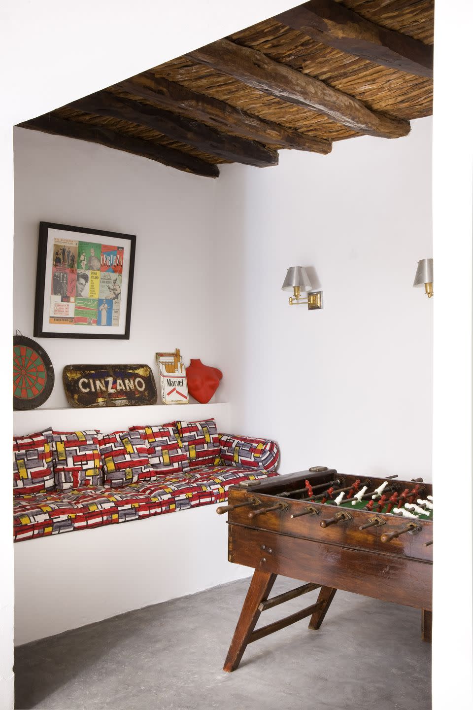 <p>The built-in sofa in this game room allows Foosball players to take a quick break between rounds, and for any visiting parties to comfortably enjoy a front row seat as the action unfolds.</p>