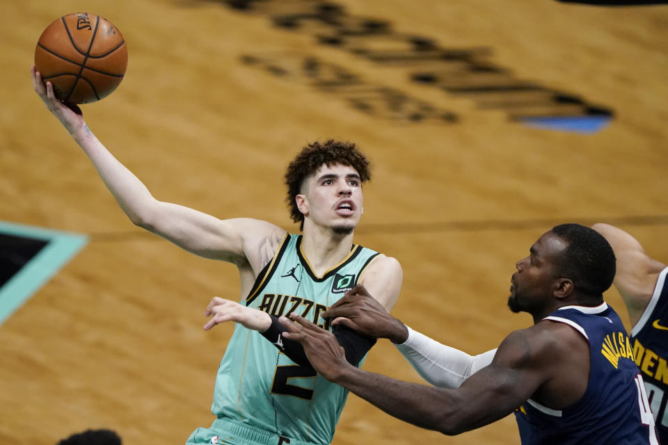 FILE - In this May 11, 2011, file photo, Charlotte Hornets guard LaMelo Ball, left, shoots over Denver Nuggets forward Paul Millsap during the second half of an NBA basketball game in Charlotte, N.C. Ball won the ESPY as best breakthrough athlete, Saturday, July 11. (AP Photo/Chris Carlson, File)