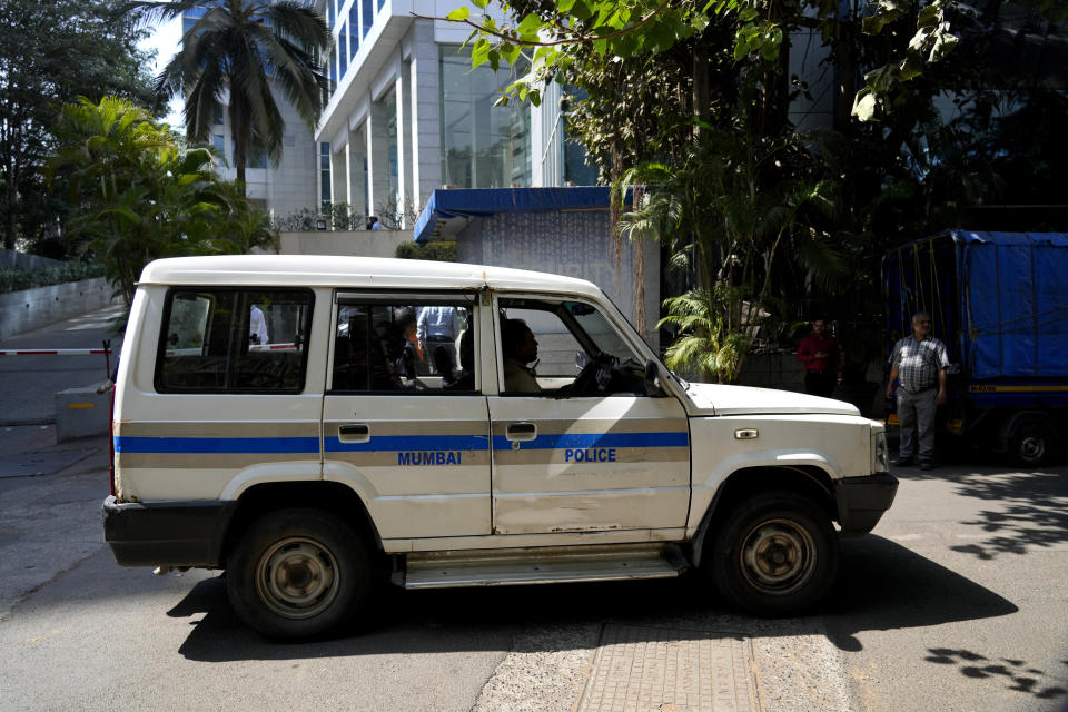 A police vehicle is seen parked at the gate of a building which houses BBC office, in Mumbai, India, Tuesday, Feb. 14, 2023. Officials from India's Income Tax department began conducting searches Tuesday at the BBC's offices in New Delhi and Mumbai, three of the broadcaster's staff members told the Associated Press. (AP Photo/Rafiq Maqbool)