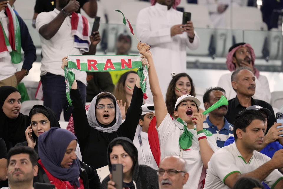 FILE - Iranian women soccer fans cheer during the World Cup group B soccer match between Iran and the United States at the Al Thumama Stadium in Doha, Qatar, Tuesday, Nov. 29, 2022. (AP Photo/Ashley Landis, File)