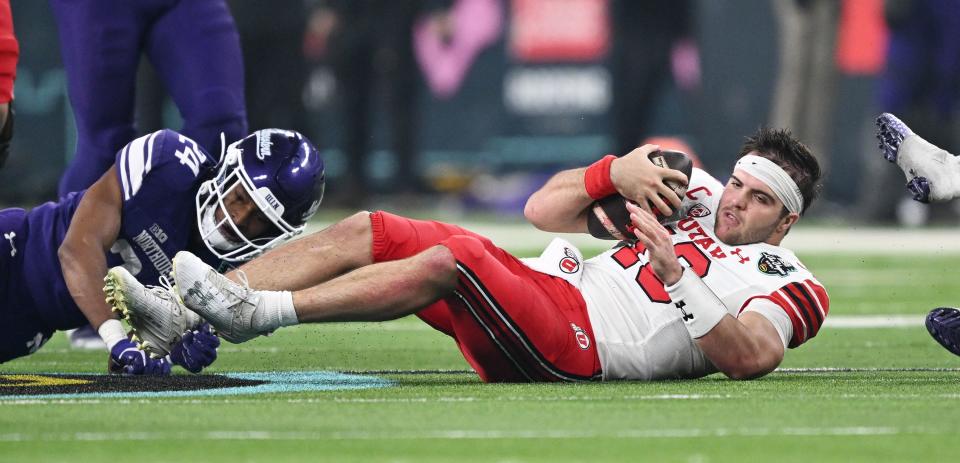 Utah Utes quarterback Bryson Barnes (16) gets up after his helmet was torn off by Northwestern Wildcats linebacker Xander Mueller (34) as Utah and Northwestern play in the SRS Distribution Las Vegas Bowl at Allegiant Stadium on Saturday, Dec. 23, 2023. Northwestern won 14-7. | Scott G Winterton, Deseret News