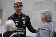 Alexander Rossi talks with race fans during a practice session for the Indianapolis 500 auto race at Indianapolis Motor Speedway, Tuesday, May 14, 2024, in Indianapolis. (AP Photo/Darron Cummings)