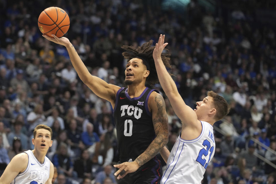 TCU guard Micah Peavy (0) goes up with the ball past BYU guard Trevin Knell (21) during the first half of an NCAA college basketball game Saturday, March 2, 2024, in Provo, Utah. (AP Photo/George Frey)