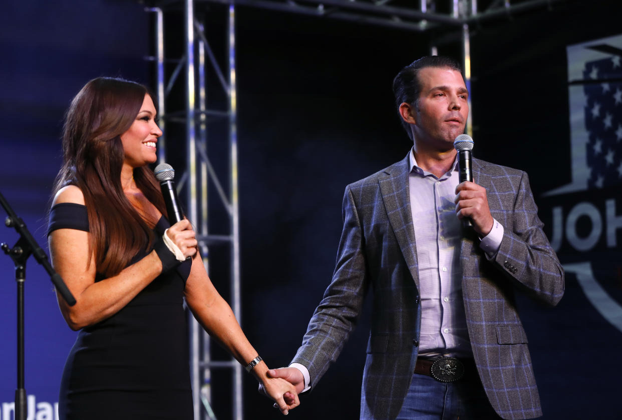 Donald Trump Jr., and Kimberly Guilfoyle hold hands during a rally for Republican U.S. Senate candidate John James in Pontiac, Mich., on Oct. 17, 2018. (Photo: AP Photo/Paul Sancya)