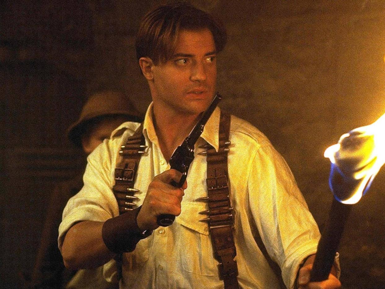 Rick O'Connell stands with a revolver in one hand and a torch in another in this scene from "The Mummy."