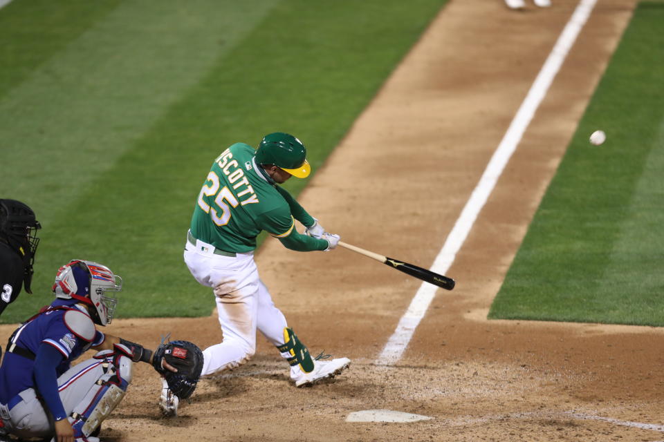 Oakland Athletics' Stephen Piscotty hits a grand slam against the Texas Rangers during the ninth inning of a baseball game in Oakland, Calif., Tuesday, Aug. 4, 2020. The A's won 5-1. (AP Photo/Jed Jacobsohn)