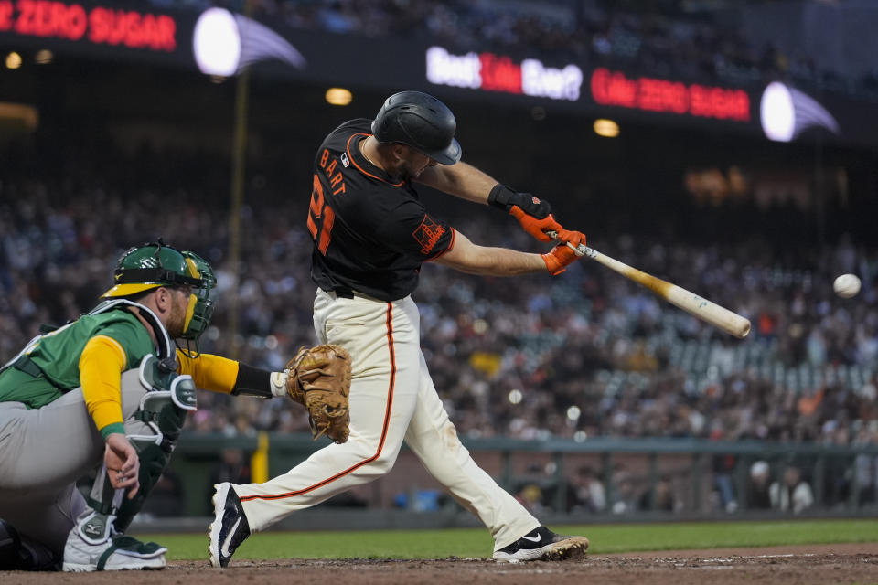 San Francisco Giants' Joey Bart hits an RBI single against the Oakland Athletics during the ninth inning of a spring training baseball game Tuesday, March 26, 2024, in San Francisco. (AP Photo/Godofredo A. Vásquez)