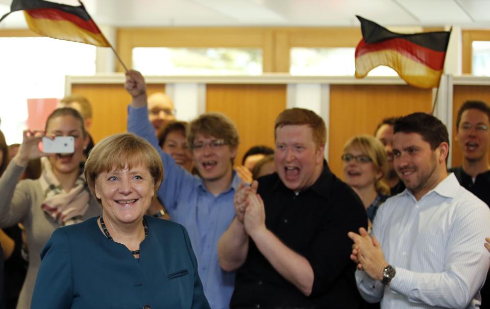 German Chancellor and leader of the Christian Democratic Union ( CDU) Angela Merkel (L) arrives for a CDU party board meeting in Berlin September 23, 2013, the day after the German general election. German Chancellor Angela Merkel faces the daunting prospect of persuading her centre-left rivals to keep her in power after her conservatives notched up their best election result in more than two decades but fell short of an absolute majority. (REUTERS/Fabrizio Bensch)