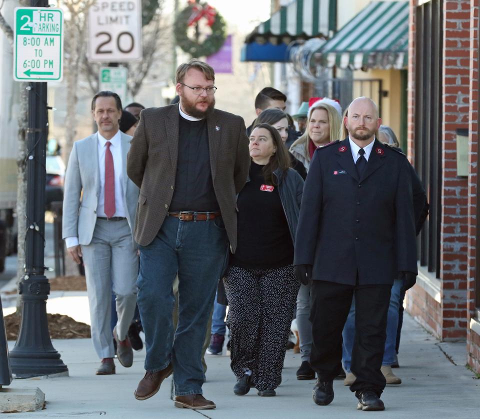 A group of people led by Salvation Army Maj. David Phelps walk along East Main Avenue as a walk of visibility and solidarity for people experiencing homelessness Wednesday morning, Dec. 21, 2022.