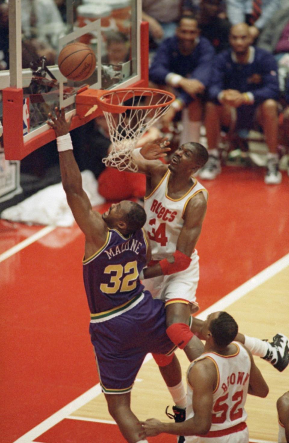 Utah Jazz forward Karl Malone (32) shoots a lay-up as <a class="link " href="https://sports.yahoo.com/nba/teams/houston/" data-i13n="sec:content-canvas;subsec:anchor_text;elm:context_link" data-ylk="slk:Houston Rockets;sec:content-canvas;subsec:anchor_text;elm:context_link;itc:0">Houston Rockets</a> center Hakeem Olajuwon (34) defends during the second half, Friday, May 5, 1995, Houston, Tex. The Rockets eliminated the Jazz in back-to-back playoffs in 1994 and 1995. | Tim Johnson, Associated Press