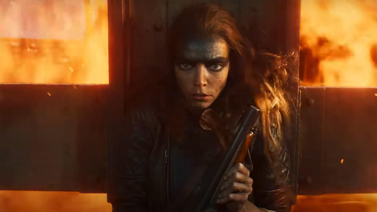  Anya Taylor-Joy's Furiosa holds a shotgun as she shelters from an explosion in Furiosa: A Mad Max Saga. 