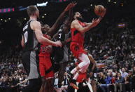Toronto Raptors guard Fred VanVleet (23) scores as Sacramento Kings guard Terence Davis (3) defends and forward Domantas Sabonis (10) defends during the first half of an NBA basketball game in Toronto on Wednesday, Dec. 14, 2022. (Nathan Denette/The Canadian Press via AP)