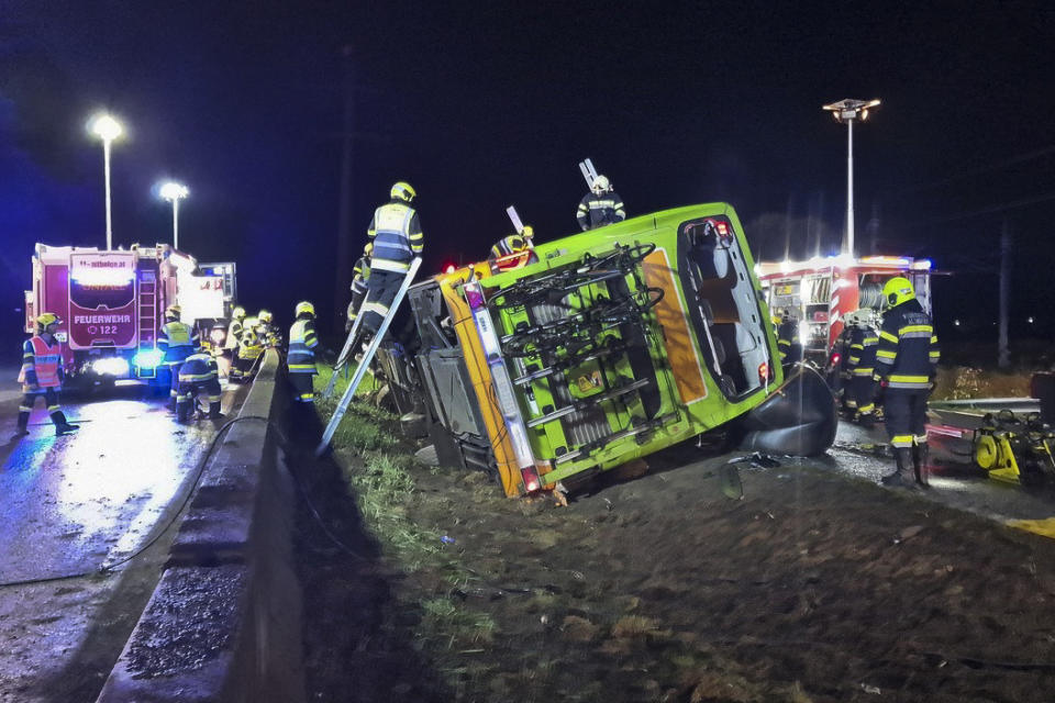 General view of the scene of a bus accident in Micheldorf, Austria, early Tuesday, Sept. 19, 2023. A bus coach traveling through Austria has driven off the road and crashed on its side, killing a woman and injuring 20 other passengers. Austrian broadcaster ORF reported the accident took place Tuesday near the village of Micheldorf in Carinthia state in central Austria. (FF-Althofen.AT via AP)