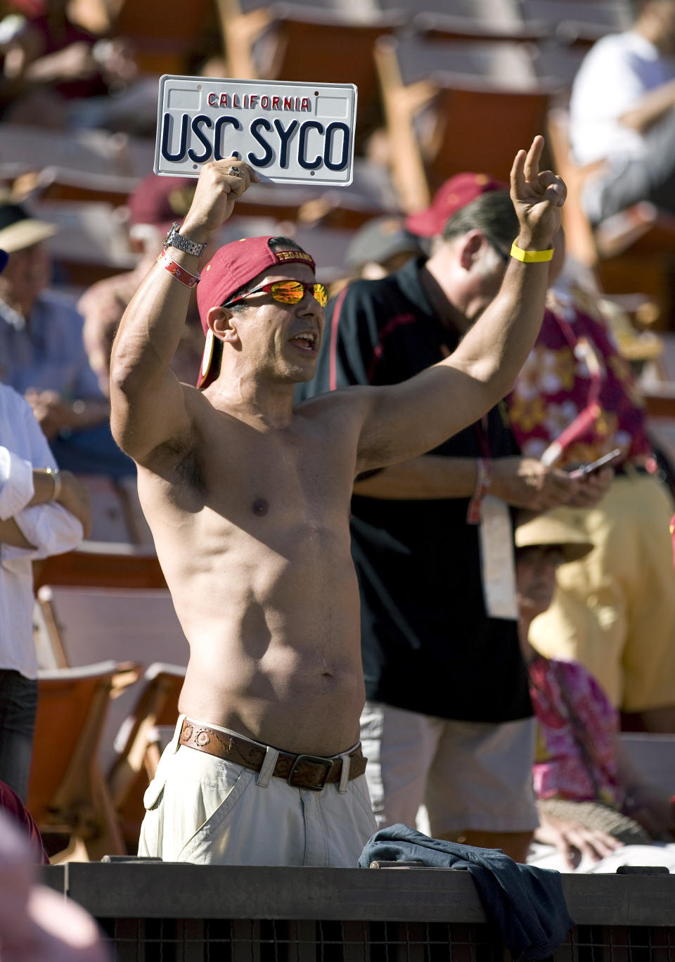 FILE - Roy Nwaisser, of Los Angeles, cheers during an NCAA college football game between the University of Southern California and Hawaii at Aloha Stadium in Honolulu, Sept. 2, 2010. Nwaisser, who hasn’t missed a Southern Cal football game home or away since 1992, said he plans to keep that streak going when USC moves to the Big Ten next year. (AP Photo/Eugene Tanner, File)