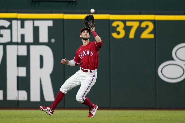 Texas Rangers outfielders Charlie Culberson, left, Leody Taveras