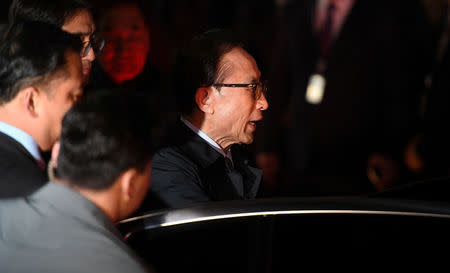Former South Korean president Lee Myung-bak gets in a car as he is transferred to a detention centre, at his residence in Seoul as he is transferred to a detention centre, at his residence in Seoul, South Korea March 23, 2018. Jung Yeon-je/Pool via Reuters
