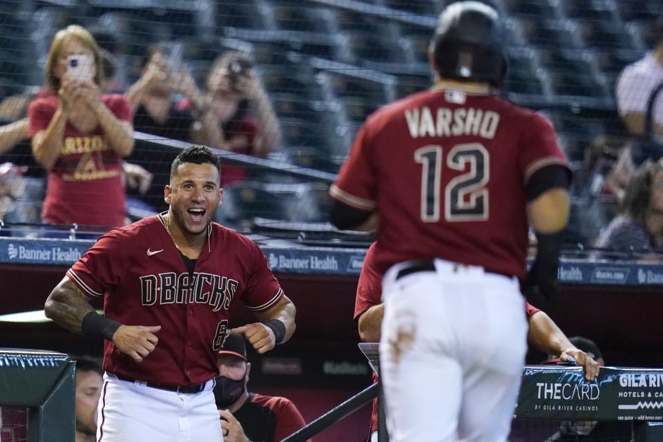 Arizona Diamondbacks' David Peralta (6) smiles as he gets ready to celebrate with Daulton Varsho (12) after Varsho's home run against the Pittsburgh Pirates during the seventh inning of a baseball game, Wednesday, July 21, 2021, in Phoenix. The Diamondbacks won 6-4. (AP Photo/Ross D. Franklin)