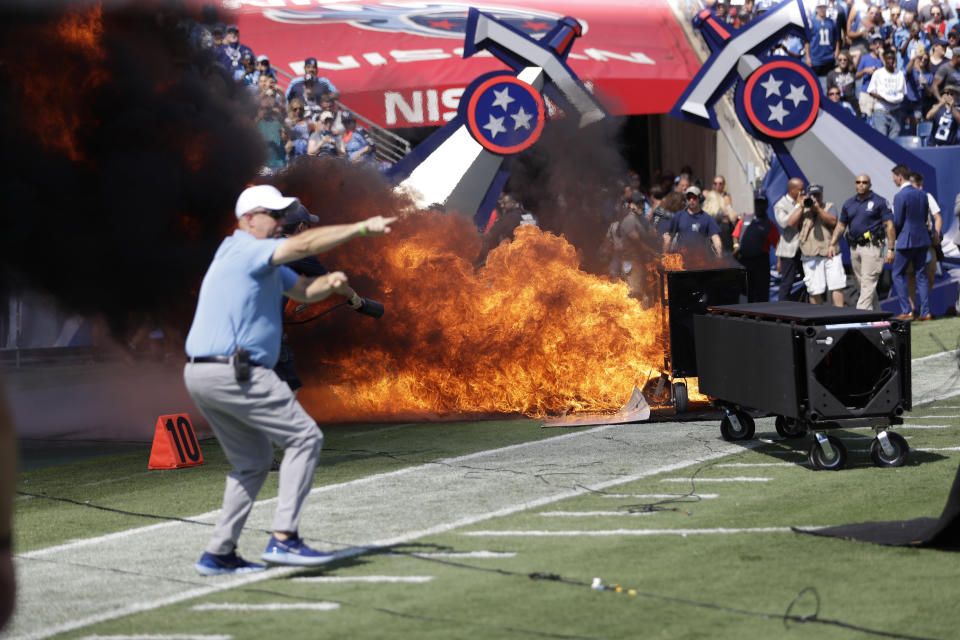 A fire from a pyrotechnics machine burns on the field before an NFL football game between the Tennessee Titans and the Indianapolis Colts. (AP)