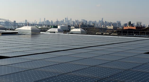The New York City skyline unfolds behind solar panels atop a restaurant in the northernmost borough of The Bronx. (Photo: DON EMMERT via Getty Images)