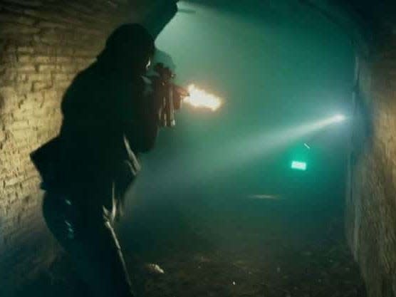 Keanu Reeves as John Wick shooting in the catacombs.