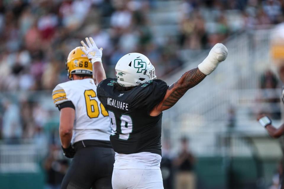 Cal Poly defensive lineman Josh Ngaluafe (99) raises his arms after a play in the Mustangs’ 42-14 loss to Idaho at Alex G. Spanos Stadium on Oct. 7, 2023.