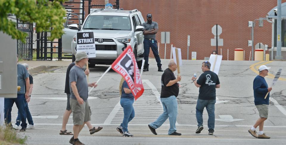 Members of the United Electrical, Radio and Machine Workers of America walk a picket line at Wabtec Corp. plant's Water Street gate in Lawrence Park Township on June 23, 2023.