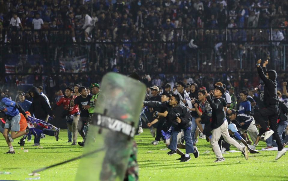 The violence erupted as supporters of both teams clashed - AP Photo/Yudha Prabowo